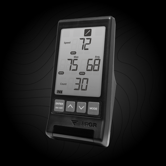 A PRGR bat speed training radar monitor displaying speed metrics on its screen, with a black background.